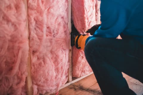 Unrecognizable worker insulating with stone wool — Erik Mclean, Pexels License
